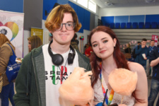 Young male and female holding candyfloss