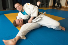 Male and female student showcase their skills at judo club